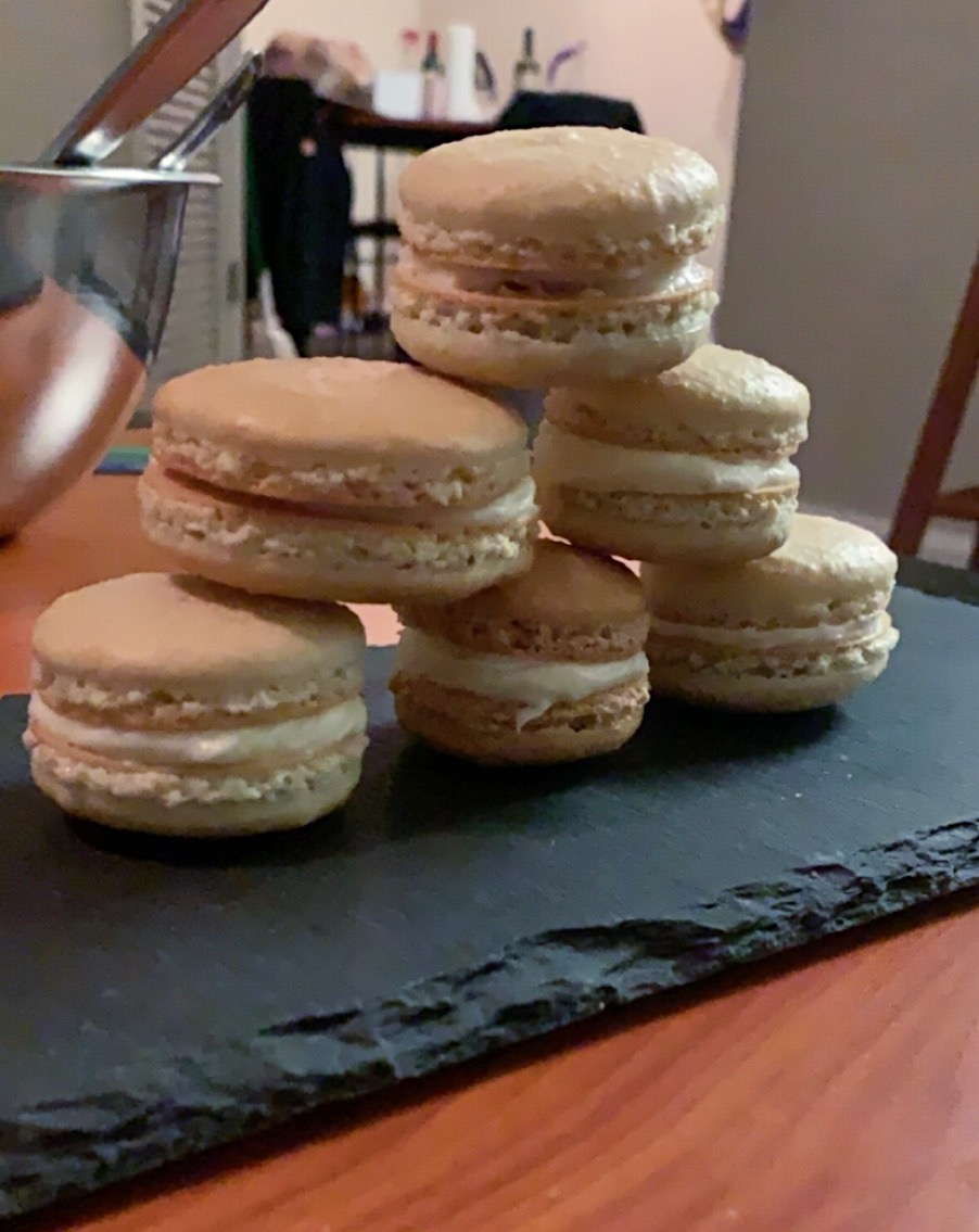 A stack of macarons on a slate board